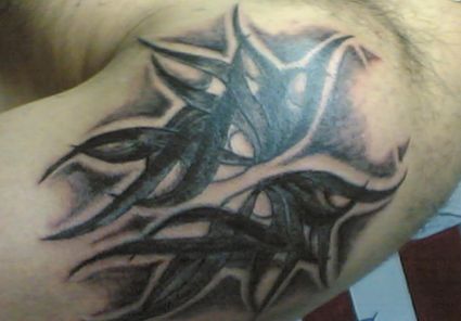 Tribal Mask Tattoo On Shoulder